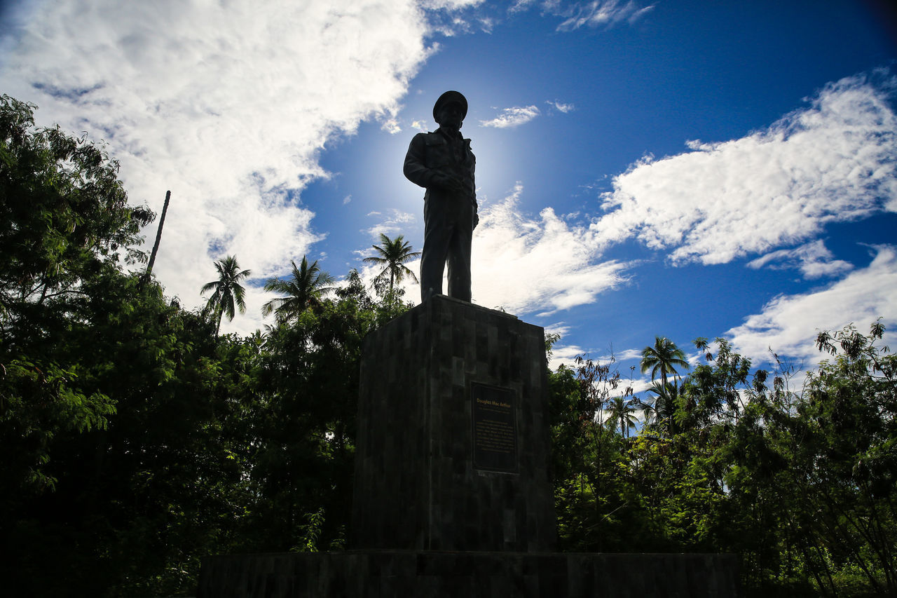 LOW ANGLE VIEW OF STATUE AGAINST TREES