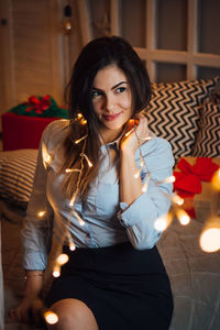 Portrait of beautiful woman sitting in kitchen