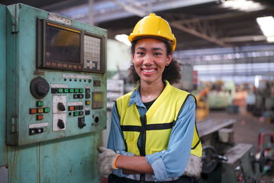 Portrait of young man working in factory