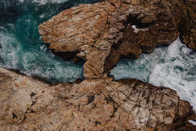 High angle view of rock formation in sea