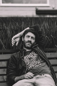 Portrait of young woman sitting on bench