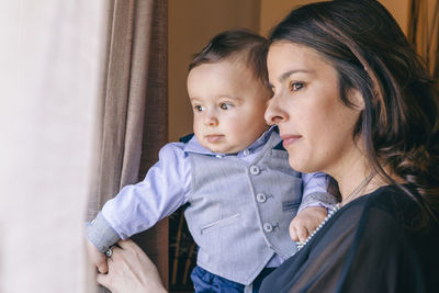 Woman with son by window at home