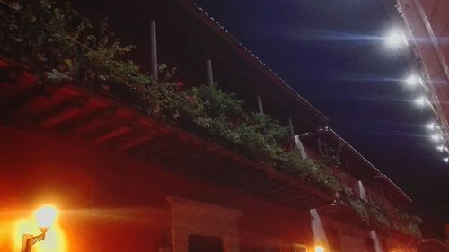 Low angle view of illuminated building against sky at night