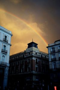 Low angle view of buildings against sky at sunset