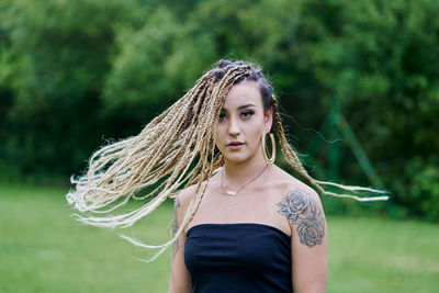 Portrait of woman standing against plants