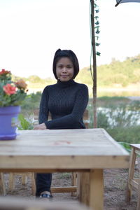 Portrait of woman sitting on bench