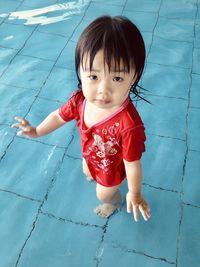 High angle view of cute girl in swimming pool