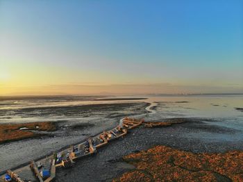 Scenic view of sea against clear sky during sunset