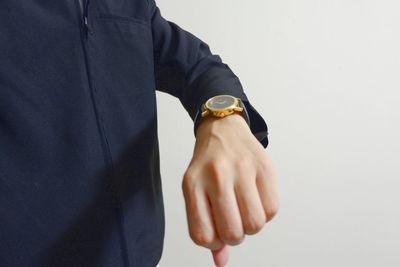 Midsection of man holding hands against white background