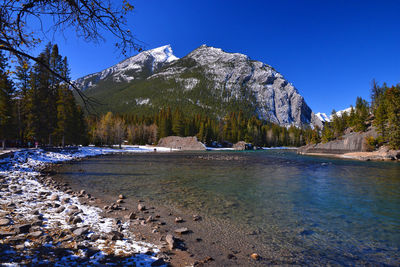 Scenic view of snowcapped mountains against clear blue sky