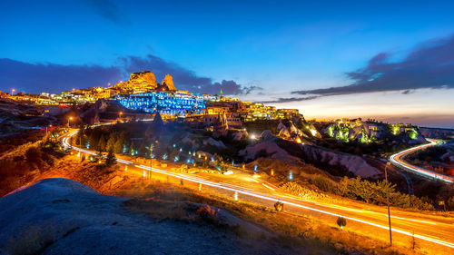 Illuminated city against sky at night