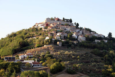 Buildings in town against clear sky