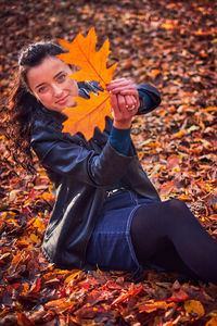 Portrait of woman with autumn leaves