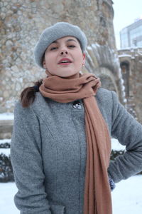 Portrait of young woman standing in snow