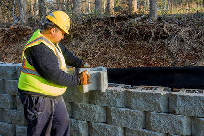 Rear view of man working at construction site