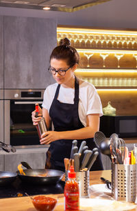 Young woman preparing food at restaurant