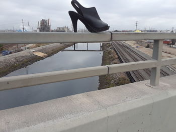 Bridge over river against buildings in city