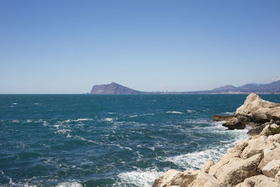 Scenic view of sea against clear blue sky