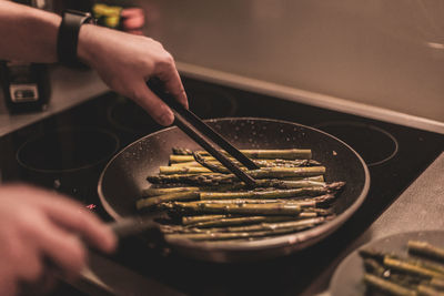 Midsection of man preparing food in kitchen