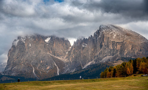 View of trees on mountain against cloudy sky