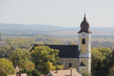 Church by building against sky