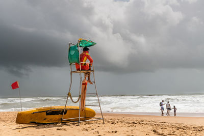 People on beach against sky