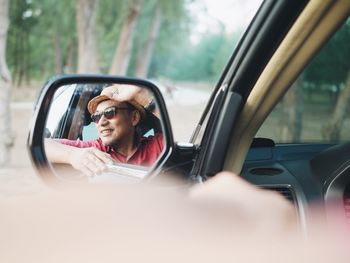 Reflection of man in car mirror