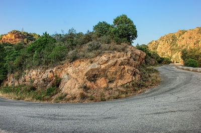 Road amidst trees against sky