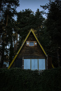 Low angle view of house amidst trees in forest