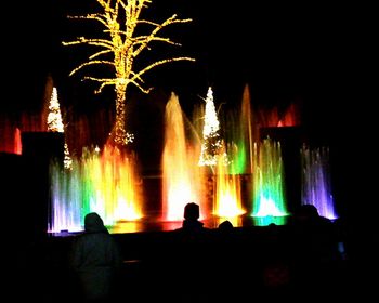 Illuminated multi colored fountains at night