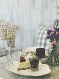 Cake with drink on plate at table