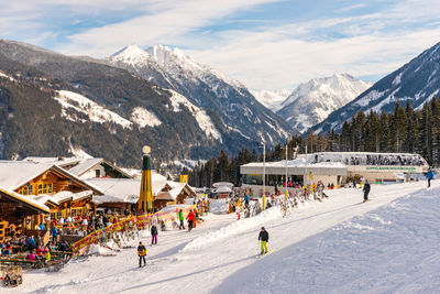 People on snowcapped mountains against sky