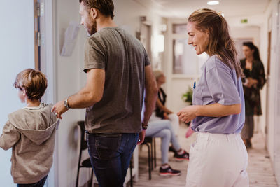 Rear view of people standing at home