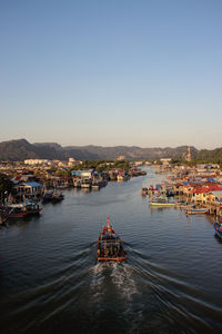 Scenic view of sea and buildings against clear sky