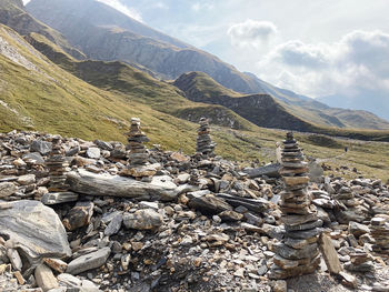 Stack of rocks on mountain against sky rock cairns, find your way, passo della greina 