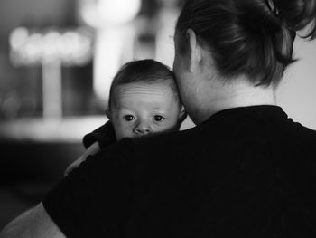 Portrait of infant resting on mother's shoulder