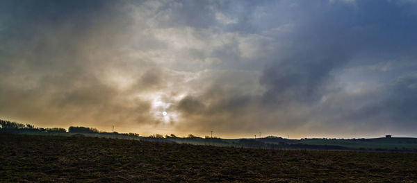 Scenic view of landscape against cloudy sky