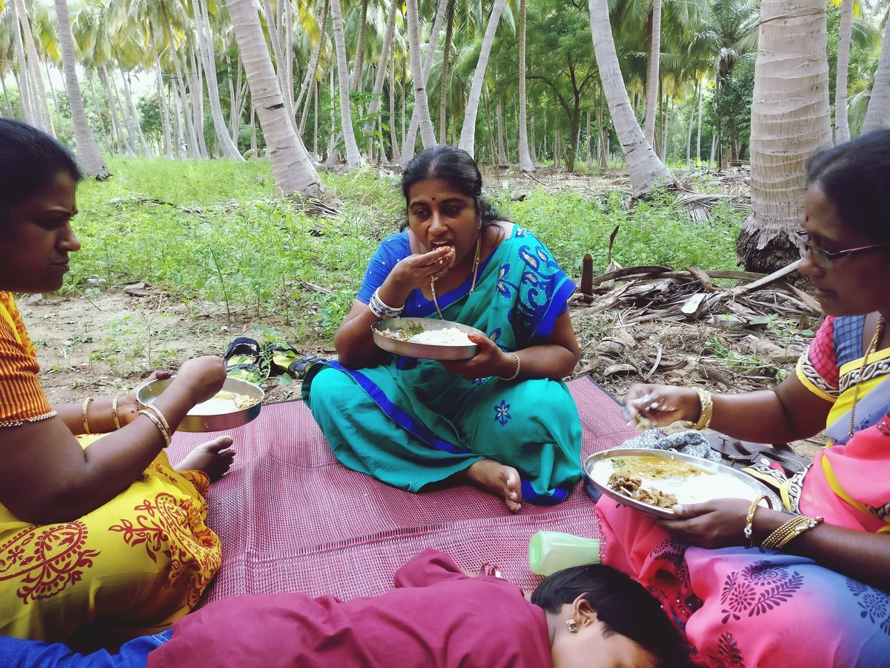 sitting, togetherness, real people, food and drink, tree, leisure activity, day, girls, casual clothing, boys, bonding, outdoors, smiling, happiness, childhood, drink, lifestyles, friendship, food, young women, young adult