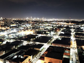 Aerial view of city lit up at night