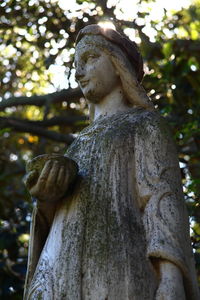 Low angle view of angel statue in cemetery