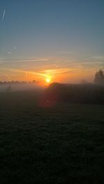 Scenic view of field against sky during sunset