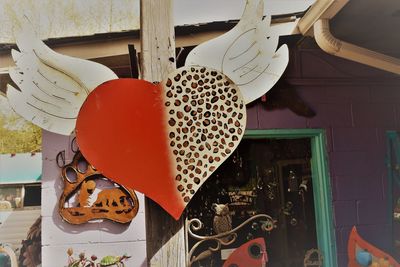 Close-up of heart shape decoration hanging on wood