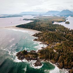 Scenic view of sea and mountains against sky,tofino beach vancouver island from above
