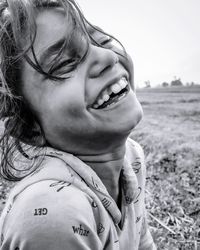 Portrait of smiling girl on field