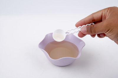 High angle view of person hand against white background