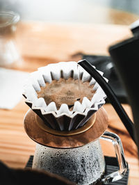 Barista pouring hot water to delicious coffee in filter. espresso coffee. using a coffee pod.