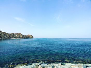 Scenic view of sea against clear blue sky