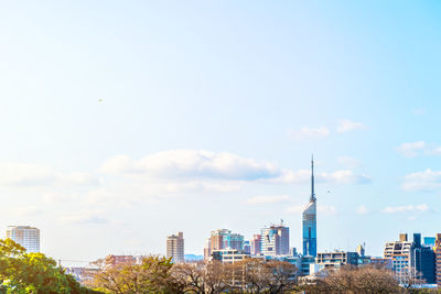 Buildings in city against sky
