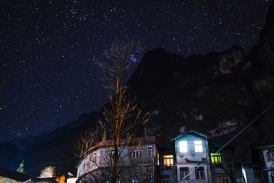 Low angle view of illuminated building against sky at night