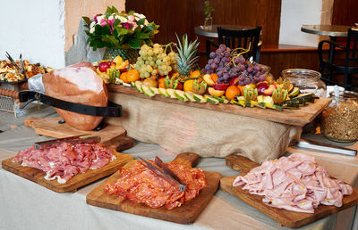 Colored buffet with seasonal fresh fruits and different kind of ham